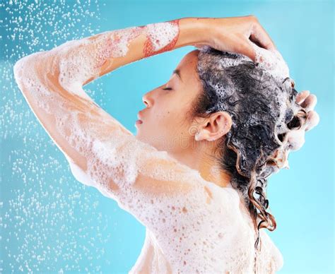 Taking A Shower Is Always So Peaceful And Rejuvenating A Woman Washing Her Hair Against A Blue