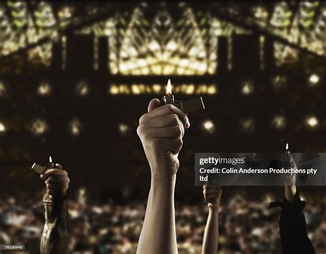 Crowd Holding Lighters Up In Audience High Res Stock Photo Getty Images