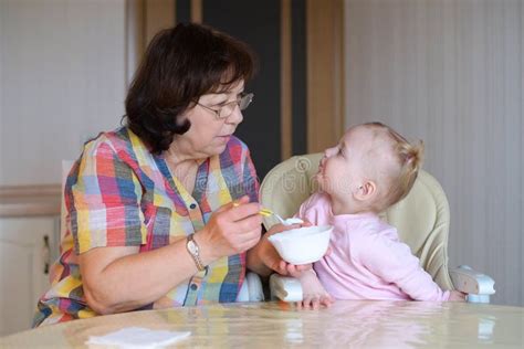 General View Of The Grandmother And Granddaughter In The Process Of