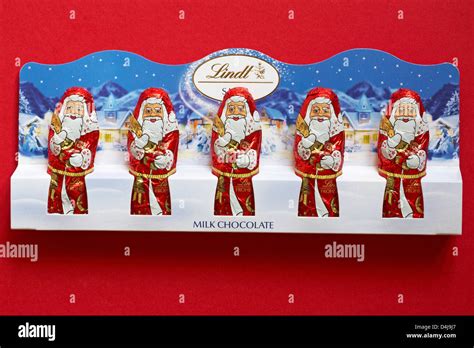 Lindt Santa Milk Chocolate Father Christmas Isolated On Red Background