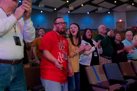 People in church clapping hands and singing • Disability Is Beautiful