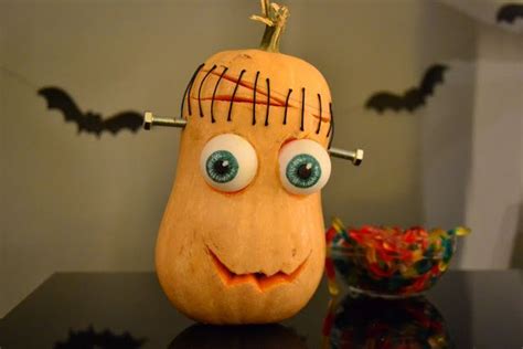 A Carved Pumpkin With Eyes And Eyebrows On It S Head Sitting Next To A