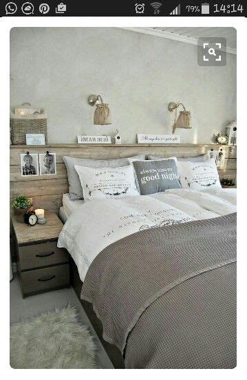 A Bed Room With A Neatly Made Bed And Two Night Stands