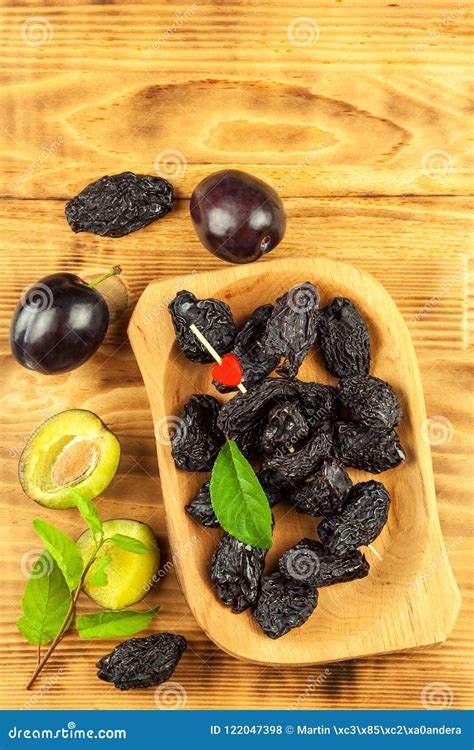 Prune, Dried Plums Fruits on Rustic Wooden Background. Dry Plums in a Wooden Bowl. Healthy Fruit ...