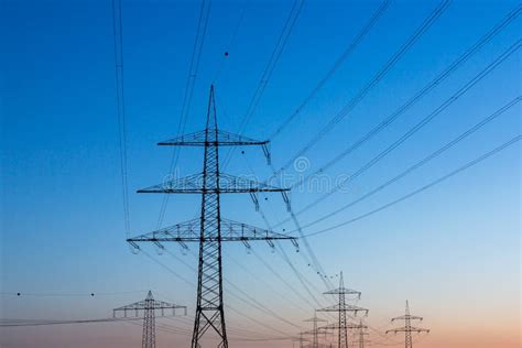 Electricity Pylons At Sunset Stock Photo Image Of Landline Pylons