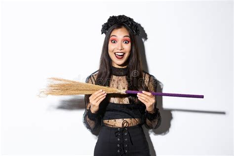 Excited Young Asian Girl In Witch Costume Looking Amazed Showing Small