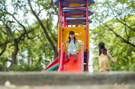 Happy Girl Having Fun On Colorful Slides Children Playing Slides At