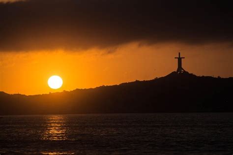 Premium Photo Sunset Over The Sea With A Large Cross In The Foreground