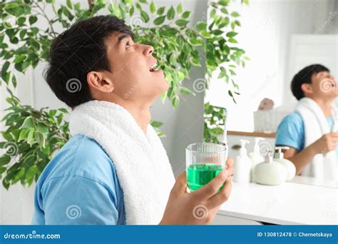 man rinsing mouth  mouthwash  bathroom stock photo image
