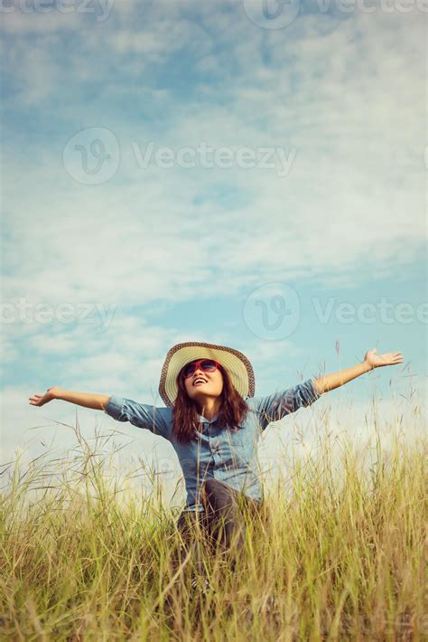 Sad young girl sitting alone on a grass outdoors,Sadness. Loneliness ...