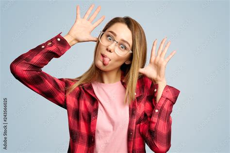 A Funny Girl In Glasses Makes Faces And Poses Her Face Sticking Her