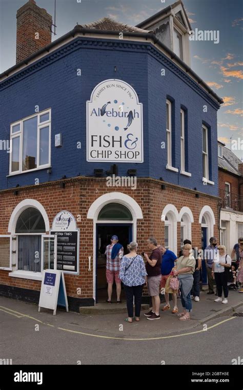 People Queuing Outside Aldeburgh Fish Chip Shop To Buy Fish And Chips