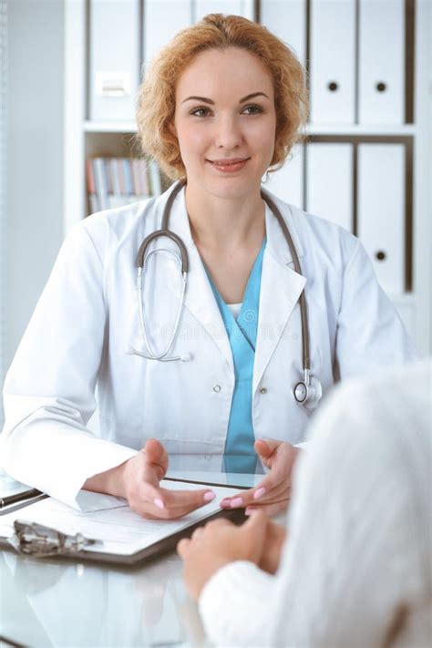Happy Blonde Female Doctor And Patient Discussing Medical Examination Results Medicine