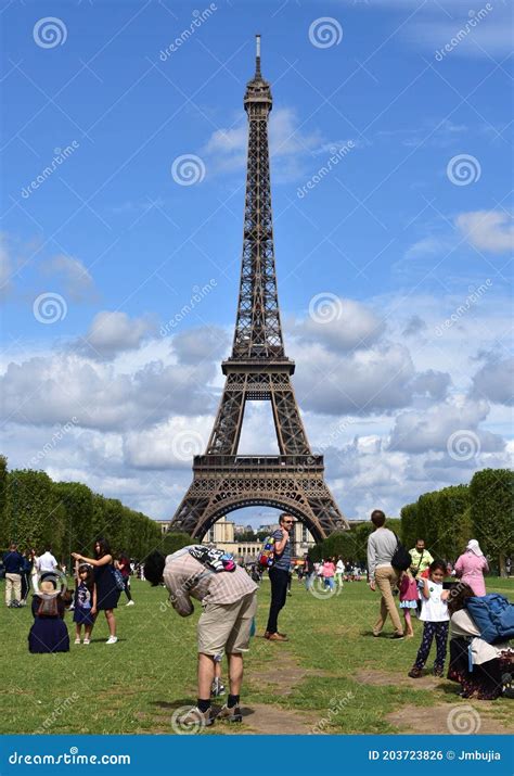 Eiffel Tower Or Tour Eiffel With Tourists Taking Pictures From Champ De