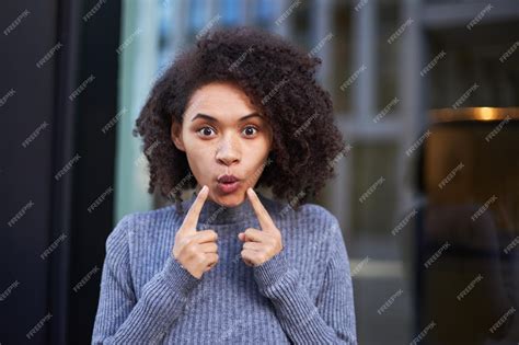 Premium Photo Beautiful Young African American Woman Pointing Index Fingers At Her Lips