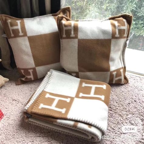 Two Brown And White Pillows Sitting On Top Of A Carpeted Floor Next To