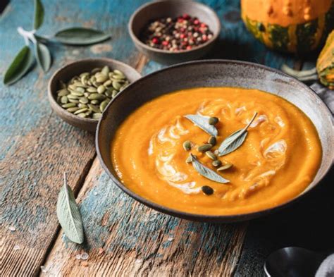 A Bowl Of Pumpkin Soup On A Table