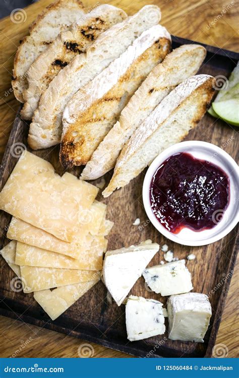 Rustic Cheese Board Platter With Bread And Redcurrant Jam Stock Photo