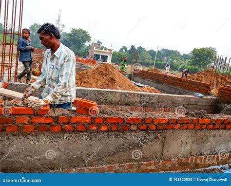 An Indian Labour Holded Brick During Wall Creation At Home Construction