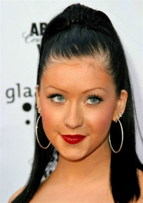 Christina Aguilera's long black hair styled into a high and tight ponytail