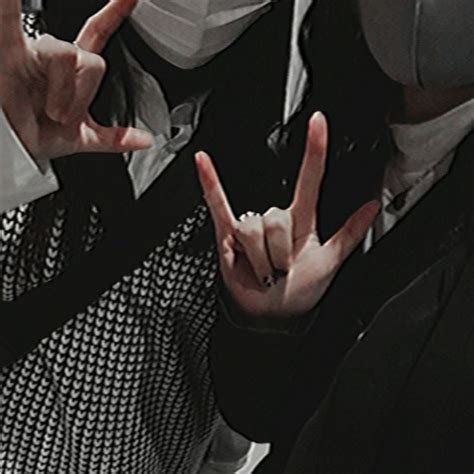 Two People Making The V Sign With Their Hands