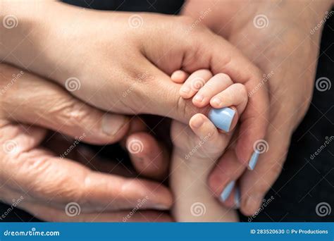 Close Up Hands Of A Baby Mother And Grandmother Stock Photo Image