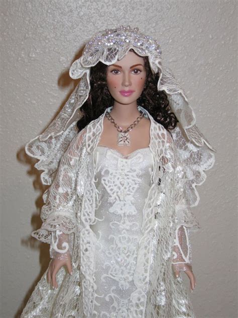 A Doll Wearing A White Wedding Dress And Veil