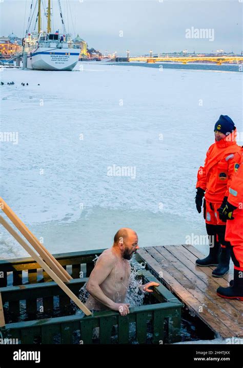 A Man Submerging In The Ice Cold Water As Orthodox Epiphany Baptism