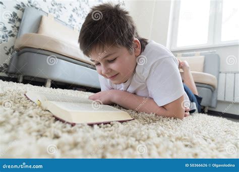 Boy Reading a Book while Lying on Carpet in the Room Stock Photo - Image of carpet, training ...