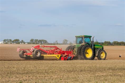 Premium Photo | Tractor plowing a field