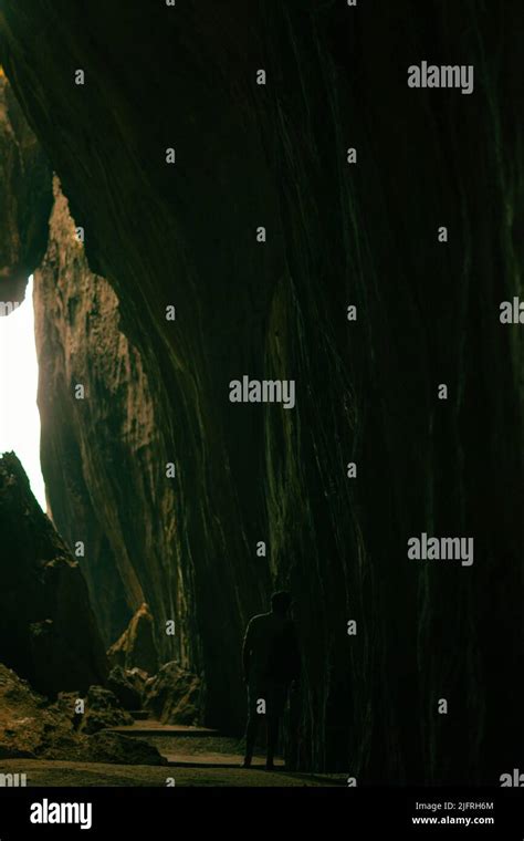 Light Coming Through Caves Alone Man Walking Under Caves Stock Photo