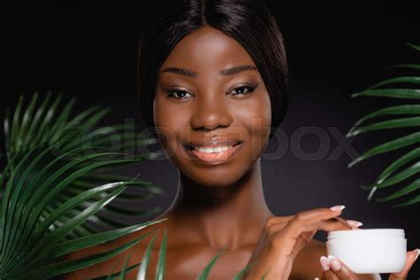 African American Naked Woman With Cosmetic Cream Near Green Palm Leaves