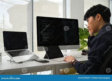 Young Man Programmer Working on Computer To Check Coding in Bugging System in it Office Stock ...