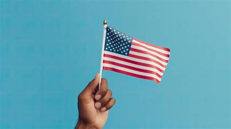 Premium Photo Hand Holding Mini United States Flag Holiday Concept