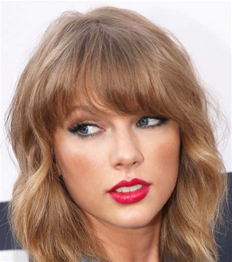 SLFMag - Taylor Swift in sky-blue eye shadow used as an...