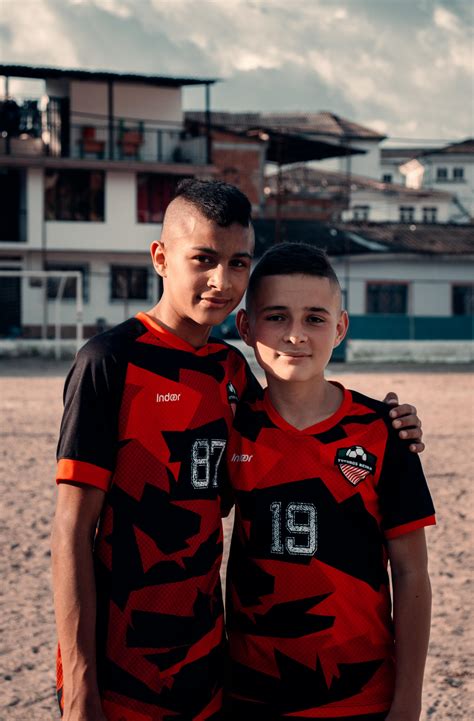 Two Boys in Red and Black Soccer Jersey · Free Stock Photo