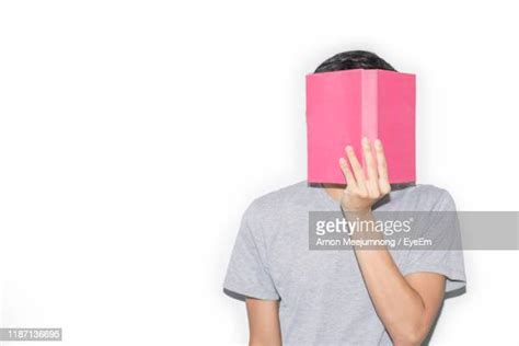 Woman Holding Book In Front Of Face Photos And Premium High Res