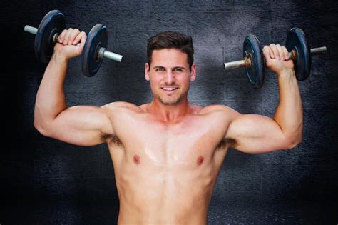 Premium Photo Bodybuilder Lifting Dumbbells Against Black Background