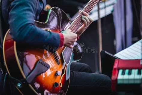 Concert View Of An Electric Acoustic Guitar Player With Vocalist And