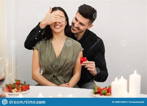 Loving Man Surprising His Girlfriend With Valentine Present Stock Image