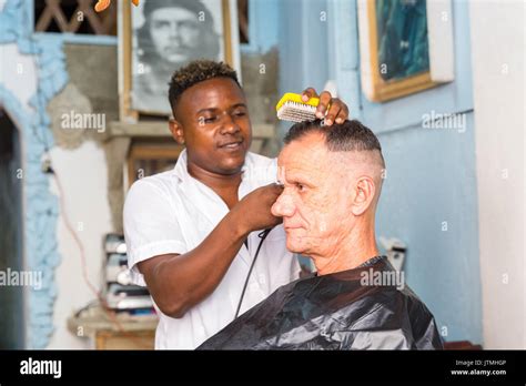 Barber Cutting A Cuban Mans Hair In A Barbershop And Hairdressing