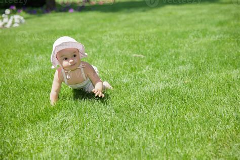 Beautiful Little Girl Crawling On The Grass 20056243 Stock Photo At