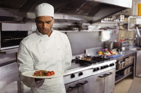 Premium Photo Chef Holding Delicious Dish In Kitchen