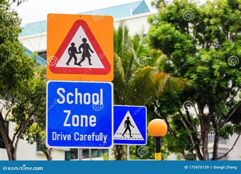 Yellow Color Warning School Zone Traffic Sign On Road Stock Image