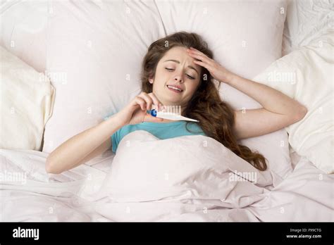 Sick Woman With Thermometer Is Lying In Bed She Has Cold Flu And High