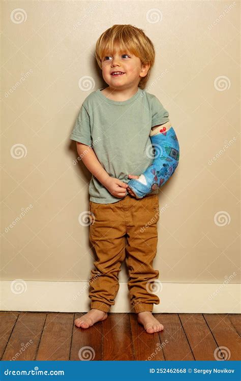 Portrait Of A Boy With Positive Expression Despite Broken Hand Stock