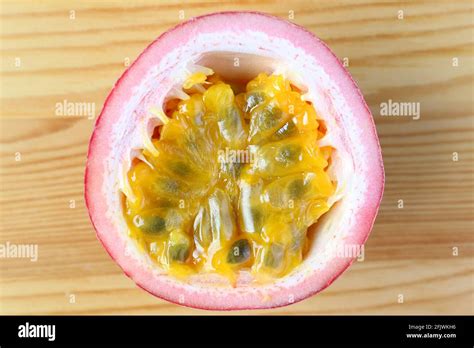 Top View Of Half Cut Fresh Ripe Passion Fruit Isolated On Wooden