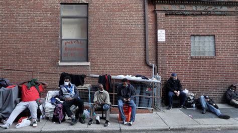 Homeless Men Sleep On Street Across From Convention Center In Philadelphia