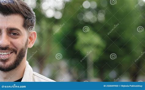 Half Face Of Bearded Man With Brown Eye While Standing Outdoors