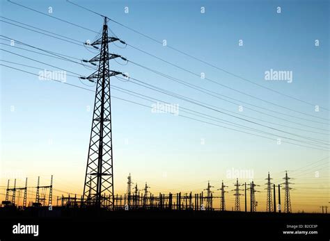 Power Substation And Pylon With Distribution Lines At Sunset Stock